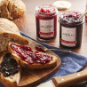 Confiture Extra de Framboise Albert Ménès, tartinée sur un toast, révélant ses morceaux de fruit