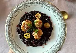 Scallops with citrus fruit and venere rice with pink berries